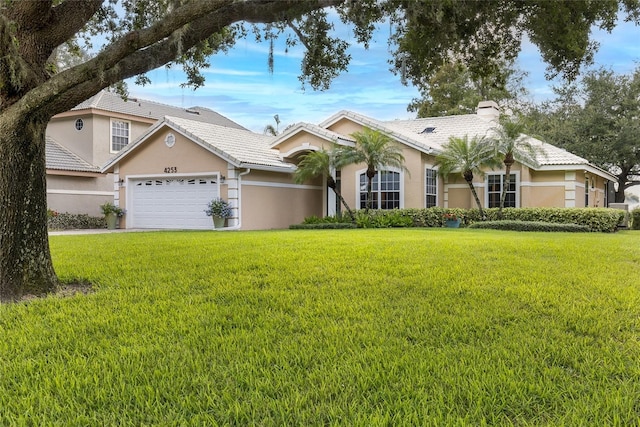 view of front of property with a front yard and a garage