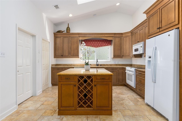 kitchen with a center island, sink, light stone counters, vaulted ceiling, and white appliances