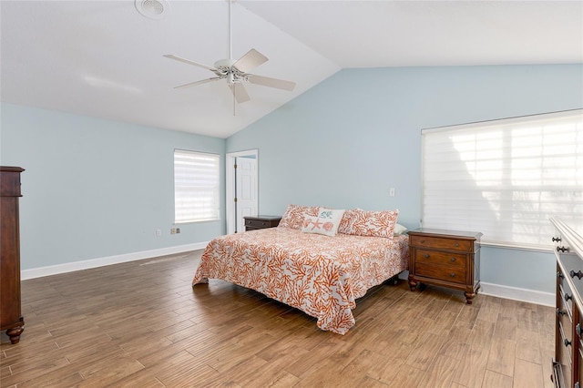 bedroom with ceiling fan, wood-type flooring, and lofted ceiling