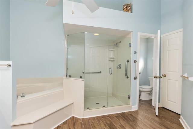 bathroom featuring toilet and separate shower and tub