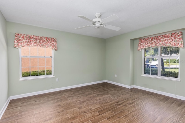 unfurnished room featuring a wealth of natural light and ceiling fan