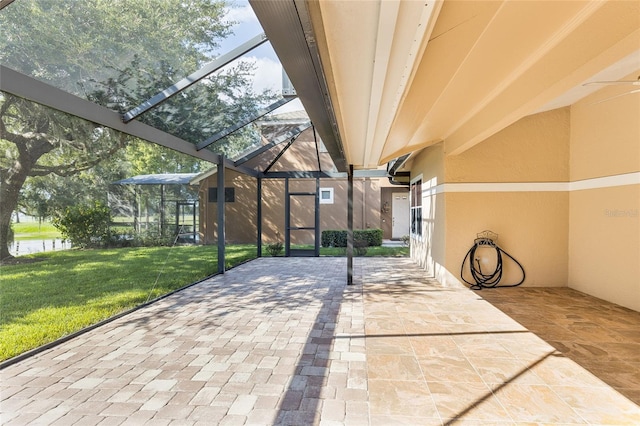 view of patio / terrace featuring glass enclosure