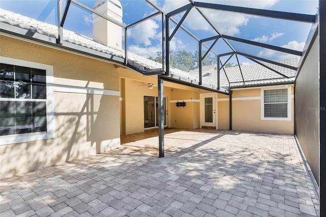 view of patio featuring a lanai