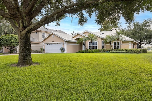 view of front of property with a garage and a front yard