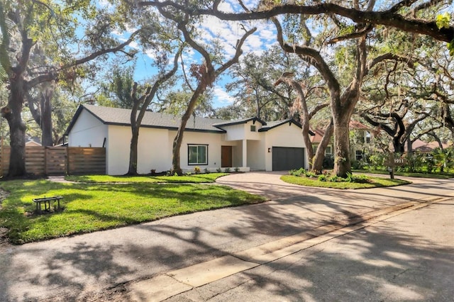 view of front of house with a garage and a front lawn