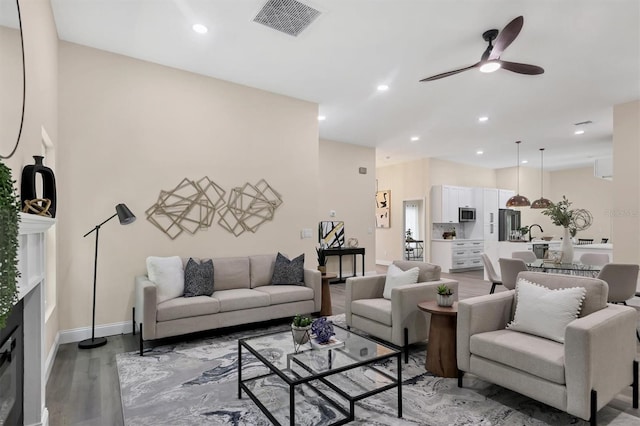 living room with hardwood / wood-style flooring and ceiling fan