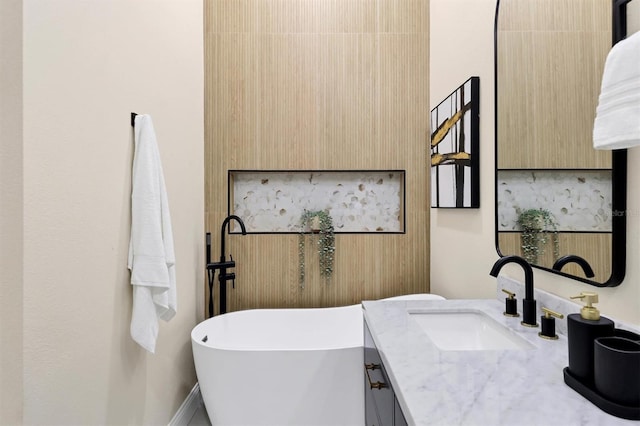 bathroom with vanity and a tub