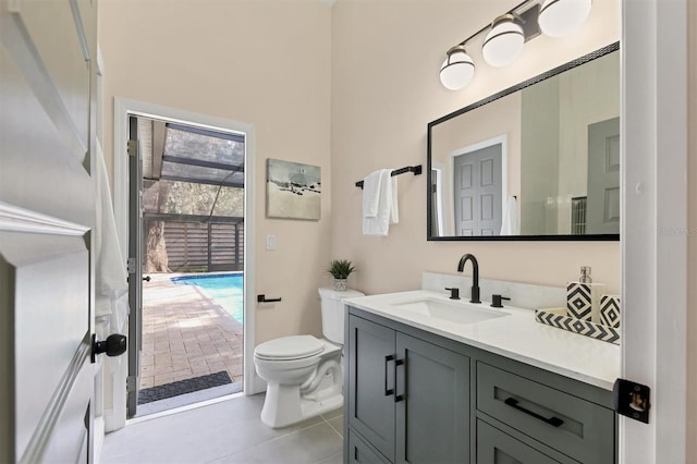 bathroom with tile patterned flooring, vanity, and toilet