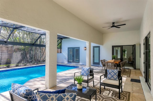 view of pool featuring french doors, a patio, ceiling fan, and a lanai