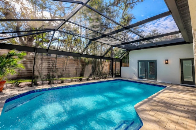 view of swimming pool with french doors, a patio, and glass enclosure