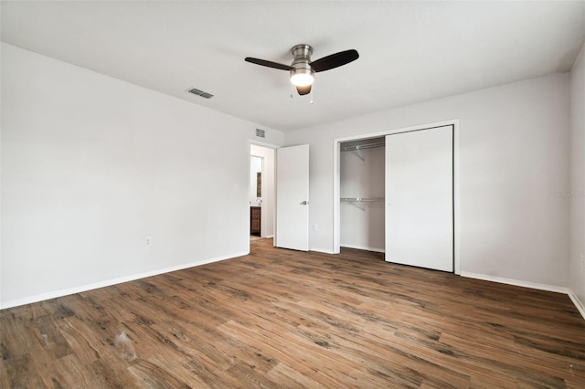 unfurnished bedroom featuring a closet, ceiling fan, and dark hardwood / wood-style flooring