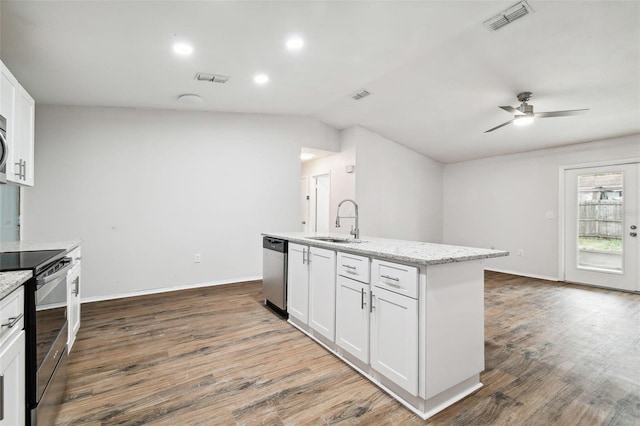 kitchen with appliances with stainless steel finishes, vaulted ceiling, ceiling fan, white cabinetry, and an island with sink