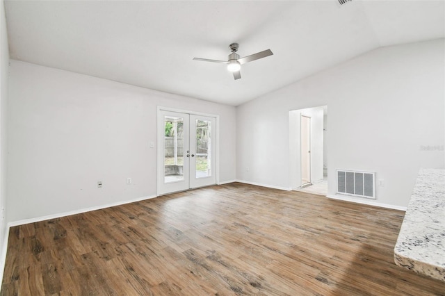 empty room with ceiling fan, french doors, wood-type flooring, and vaulted ceiling