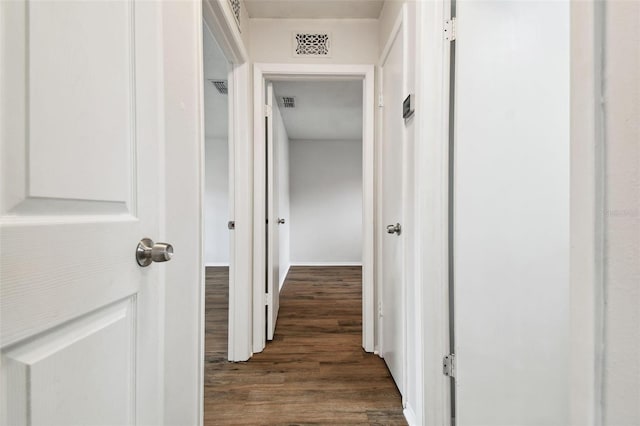 hallway with dark hardwood / wood-style flooring