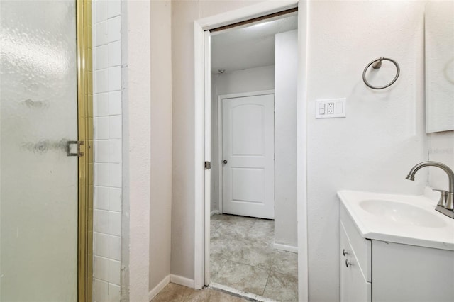 bathroom featuring vanity and an enclosed shower