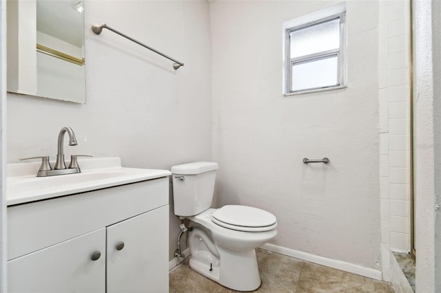 bathroom featuring vanity, toilet, and walk in shower