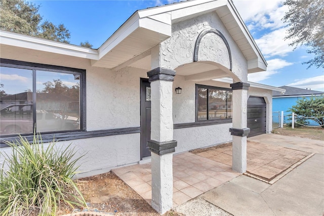 doorway to property with a garage