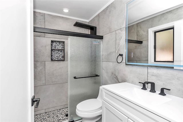 bathroom featuring crown molding, tile walls, tiled shower, vanity, and toilet