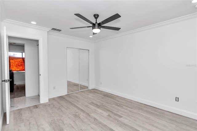 unfurnished bedroom featuring crown molding, a closet, and ceiling fan