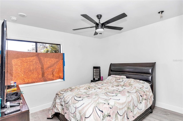 bedroom with ceiling fan and light hardwood / wood-style flooring