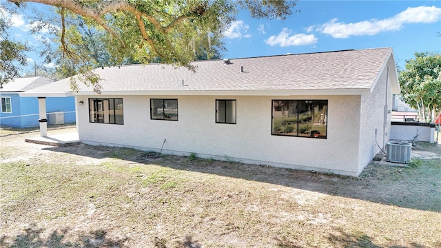 back of property featuring central AC