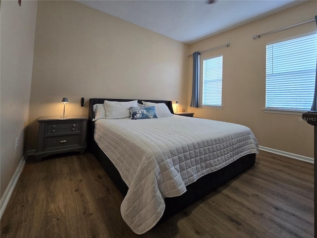 bedroom with dark wood-type flooring