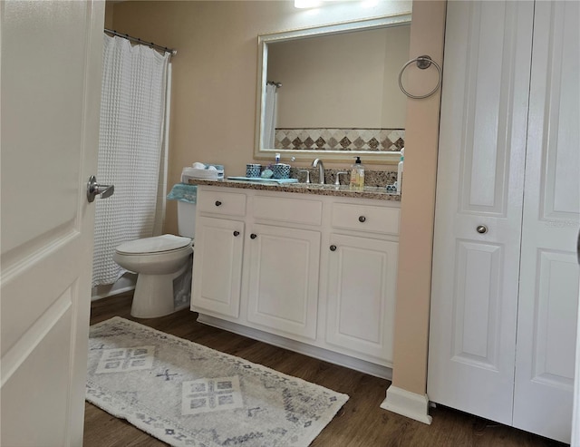 bathroom featuring hardwood / wood-style flooring, vanity, and toilet