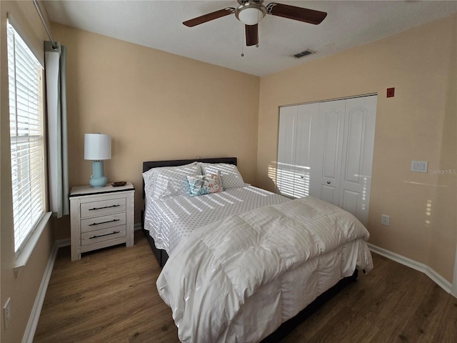 bedroom featuring ceiling fan, a closet, and dark hardwood / wood-style floors