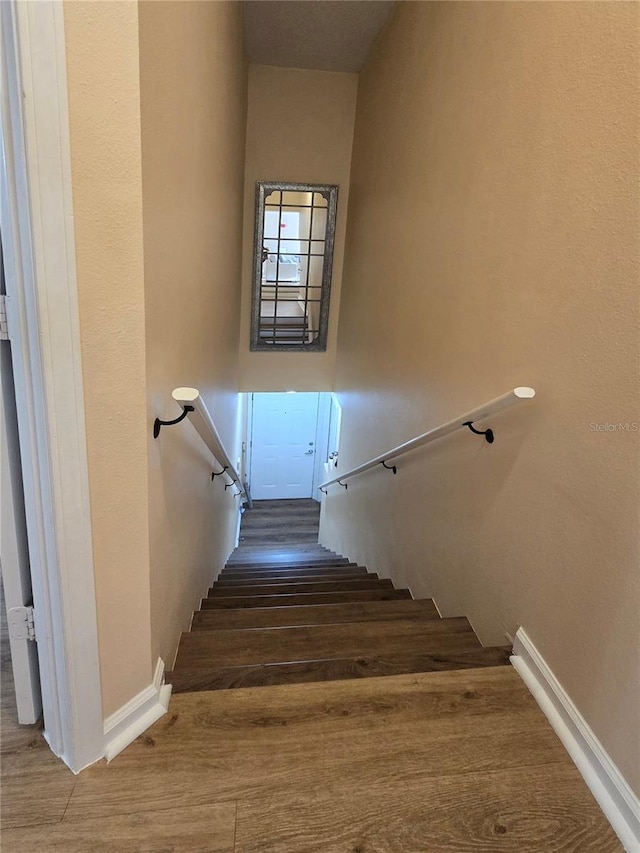 stairs featuring wood-type flooring