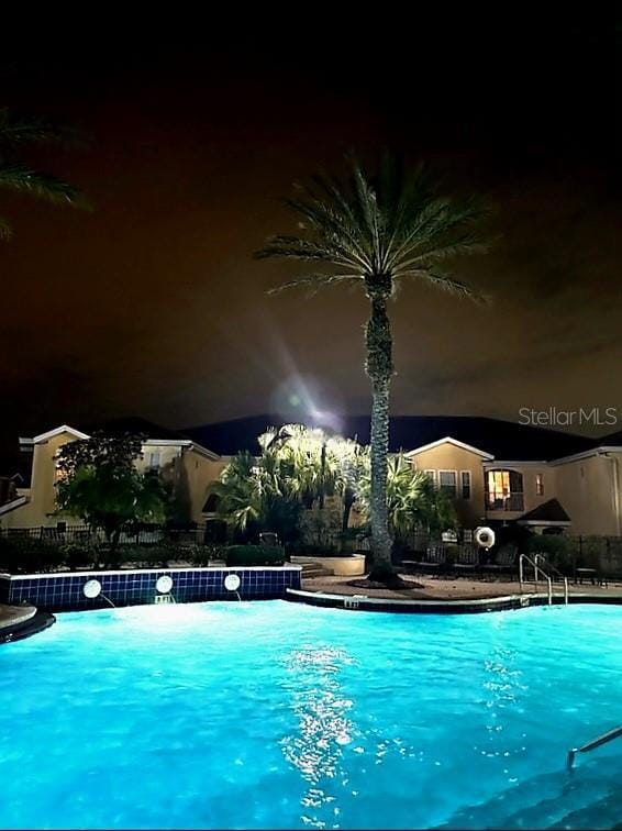 view of pool at night