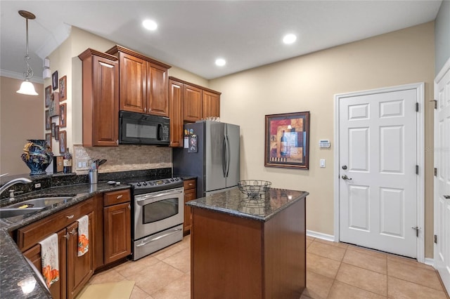 kitchen featuring dark stone counters, hanging light fixtures, sink, light tile patterned floors, and appliances with stainless steel finishes