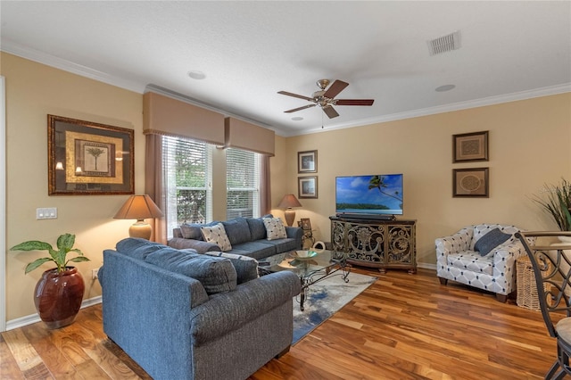 living room with crown molding, ceiling fan, and wood-type flooring