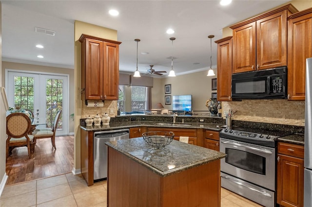 kitchen with kitchen peninsula, stainless steel appliances, pendant lighting, light tile patterned floors, and a kitchen island