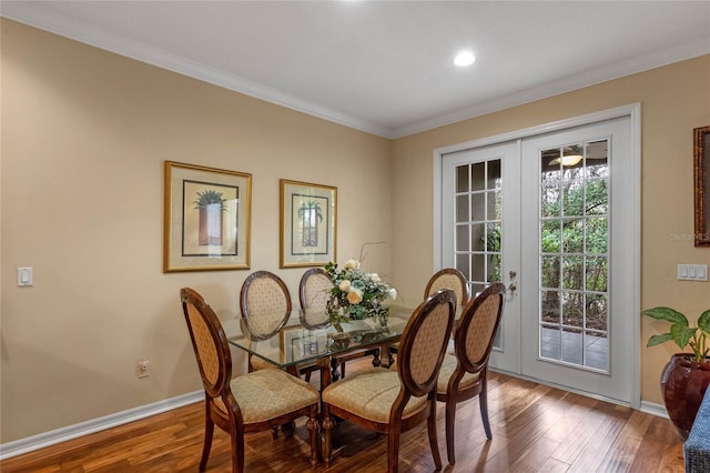 dining area featuring hardwood / wood-style floors, ornamental molding, and french doors