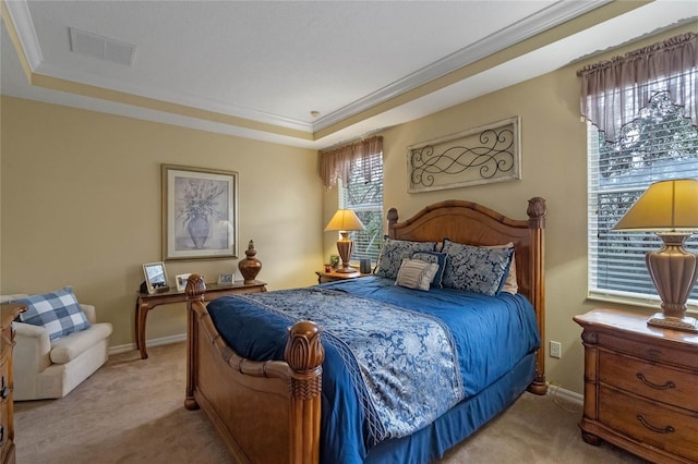 bedroom with light carpet and a tray ceiling