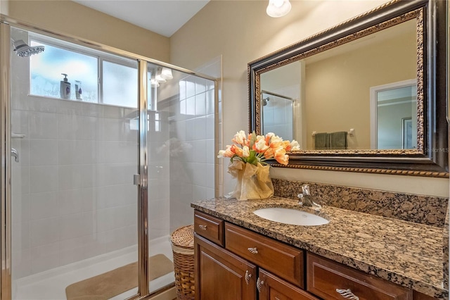 bathroom featuring vanity and a shower with shower door