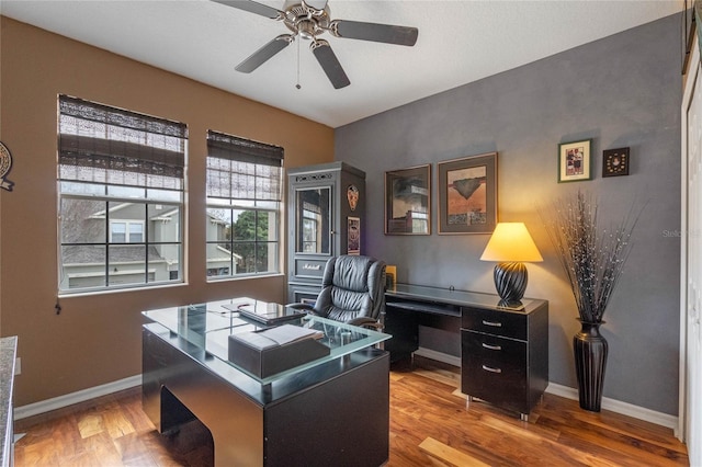 home office with wood-type flooring and ceiling fan