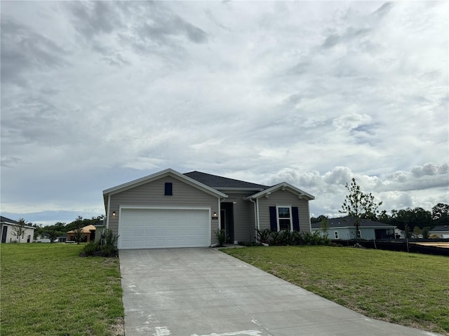 view of front of house with a front yard and a garage