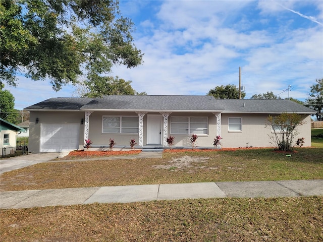 ranch-style home with a front yard and a garage