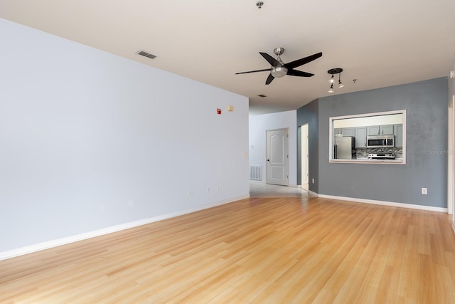 unfurnished living room with ceiling fan and light hardwood / wood-style floors