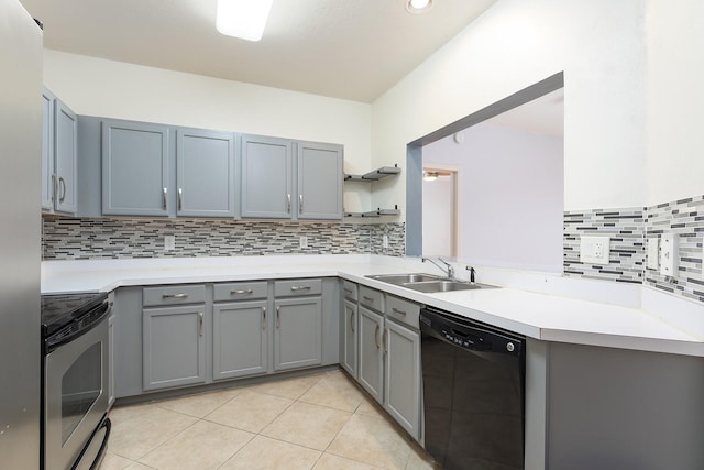 kitchen with black dishwasher, sink, stainless steel electric range oven, light tile patterned flooring, and gray cabinetry