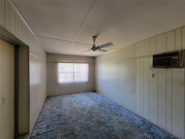 spare room featuring a wall mounted air conditioner, light colored carpet, and ceiling fan