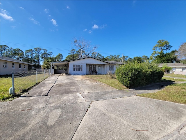 ranch-style house with a front yard and a carport