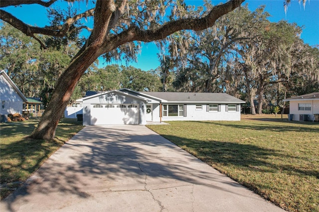 single story home featuring a front yard and a garage