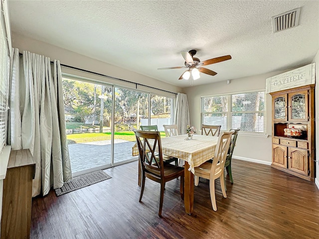 dining area featuring ceiling fan, dark hardwood / wood-style flooring, and a textured ceiling