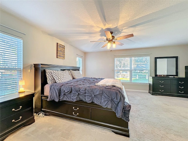 bedroom with ceiling fan and light colored carpet