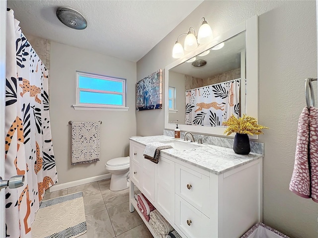 bathroom with a textured ceiling, vanity, toilet, and a shower with curtain