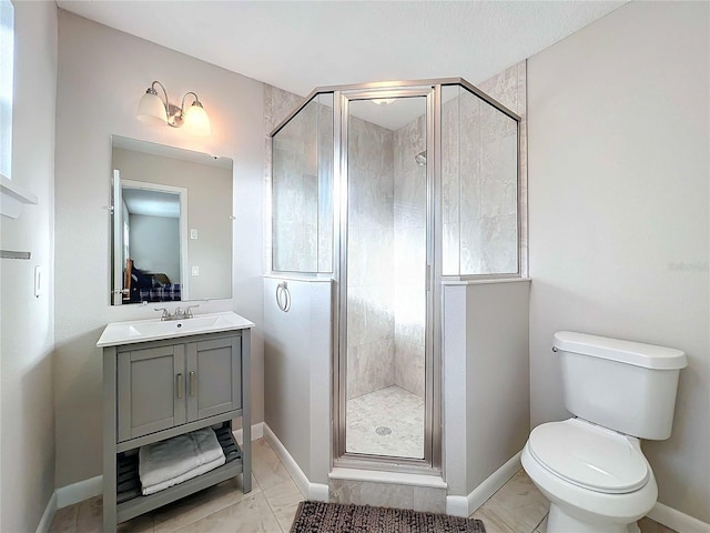 bathroom featuring vanity, toilet, and a shower with door