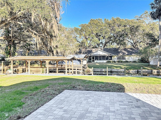 view of property's community with a yard and a patio area