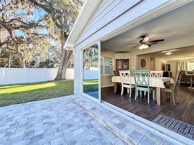 exterior space with ceiling fan